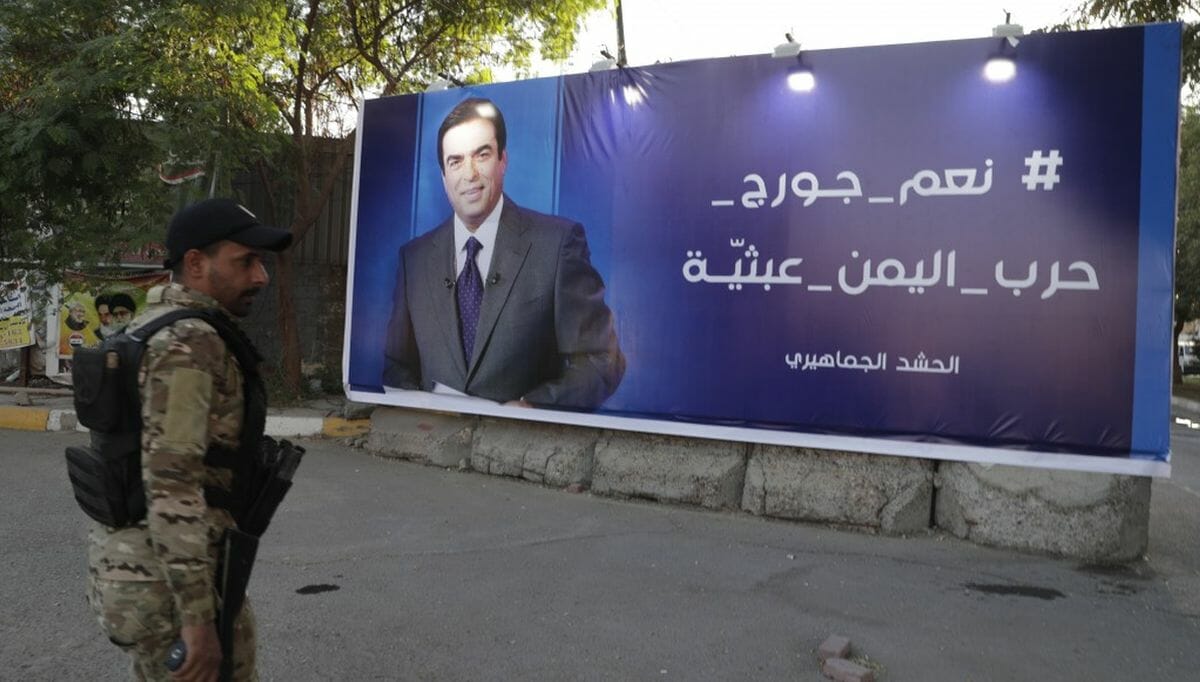 Schiitischer Milizionär vor einem Wahlplakat George Kordahis
